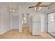 Bright kitchen features tile flooring, a white refrigerator, and a ceiling fan with light fixture at 6521 Faith Peak Dr, Las Vegas, NV 89108