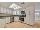 Modern kitchen showcasing stainless steel appliances, ample cabinet space, and tiled floors at 6521 Faith Peak Dr, Las Vegas, NV 89108