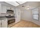 A well-equipped kitchen features modern appliances, a window, and tile flooring at 6521 Faith Peak Dr, Las Vegas, NV 89108