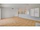 Open-concept living room with tile flooring and a large window, bright and airy at 6521 Faith Peak Dr, Las Vegas, NV 89108