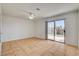 Spacious room features a sliding glass door to the outside and neutral tile flooring throughout at 6521 Faith Peak Dr, Las Vegas, NV 89108