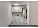 Water heater area with storage cabinets in the garage at 6521 Faith Peak Dr, Las Vegas, NV 89108