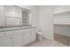 This bathroom features a white vanity, gray countertop and mirror, with a shower and access to a walk-in closet at 6761 Violet Cascade Ave, Las Vegas, NV 89156