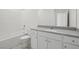This full bathroom features a shower and tub combo, a gray countertop vanity, and a toilet at 6761 Violet Cascade Ave, Las Vegas, NV 89156