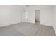 This bedroom offers neutral carpeting and is freshly painted with a connected ensuite bathroom at 6761 Violet Cascade Ave, Las Vegas, NV 89156