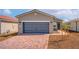 Charming single-story home featuring a two-car garage and a brick paved driveway at 6761 Violet Cascade Ave, Las Vegas, NV 89156