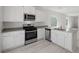 Modern kitchen with stainless steel appliances, white cabinets, and quartz countertops at 6761 Violet Cascade Ave, Las Vegas, NV 89156