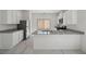 Modern kitchen with stainless steel appliances, white cabinets, and quartz countertops at 6761 Violet Cascade Ave, Las Vegas, NV 89156