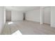 Bright, open-concept living area with light hardwood floors and white walls at 6761 Violet Cascade Ave, Las Vegas, NV 89156