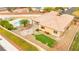 Stunning aerial view of backyard oasis featuring a pool, fire pit, and lush landscaping, perfect for outdoor entertaining at 7119 Wolf Rivers Ave, Las Vegas, NV 89131