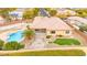 Aerial view of a property featuring a pool, terraced backyard, manicured lawn, and desert landscaping at 7119 Wolf Rivers Ave, Las Vegas, NV 89131