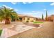 Backyard with a fire pit, terraced landscaping, and a grass area, creating a perfect outdoor retreat at 7119 Wolf Rivers Ave, Las Vegas, NV 89131