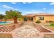 Expansive backyard featuring a fire pit, terraced landscaping, and access to the pool and patio at 7119 Wolf Rivers Ave, Las Vegas, NV 89131