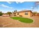 Well-maintained backyard with desert landscaping, a grass area, and view of the outdoor living space at 7119 Wolf Rivers Ave, Las Vegas, NV 89131