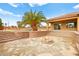 Outdoor space featuring terraced landscaping with a fire pit, steps to the pool, and mature palm trees at 7119 Wolf Rivers Ave, Las Vegas, NV 89131