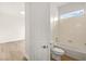 Bathroom with a tub and shower, with wood look flooring at 7119 Wolf Rivers Ave, Las Vegas, NV 89131