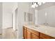 Bathroom vanity with cabinets, large mirror and wood look flooring at 7119 Wolf Rivers Ave, Las Vegas, NV 89131
