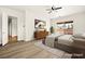 Staged bedroom with modern furniture, sliding glass doors, and wood-look floors at 7119 Wolf Rivers Ave, Las Vegas, NV 89131