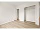 Bright bedroom with an open closet and light wood laminate flooring at 7119 Wolf Rivers Ave, Las Vegas, NV 89131