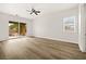 Spacious bedroom with sliding glass doors to the backyard and wood-look flooring at 7119 Wolf Rivers Ave, Las Vegas, NV 89131