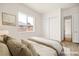 Virtual staged bedroom with ample natural light and a double door closet at 7119 Wolf Rivers Ave, Las Vegas, NV 89131