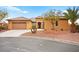 Charming front exterior featuring a well-manicured yard and a spacious three-car garage at 7119 Wolf Rivers Ave, Las Vegas, NV 89131