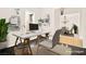 Staged home office with modern desk setup and view into the adjacent staged dining area at 7119 Wolf Rivers Ave, Las Vegas, NV 89131