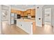 Open kitchen featuring stainless steel appliances, wooden cabinetry, a center island, and tile flooring for a classic design at 7119 Wolf Rivers Ave, Las Vegas, NV 89131
