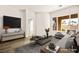 Living room featuring a neutral color palette, modern decor, and an abundance of natural light at 7119 Wolf Rivers Ave, Las Vegas, NV 89131