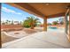Covered patio overlooking pool, and a sunken fire pit at 7119 Wolf Rivers Ave, Las Vegas, NV 89131