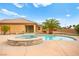 Backyard pool with hot tub and a palm tree at 7119 Wolf Rivers Ave, Las Vegas, NV 89131