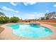 Backyard pool with hot tub and landscaped surroundings at 7119 Wolf Rivers Ave, Las Vegas, NV 89131