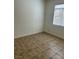 Small bedroom featuring tile floors and a window with blinds at 7228 Chic Ave, Las Vegas, NV 89129