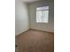 Small bedroom with neutral walls and carpet and a bright window at 7228 Chic Ave, Las Vegas, NV 89129