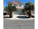 Charming two-story home featuring a two-car garage and desert landscaping at 7228 Chic Ave, Las Vegas, NV 89129