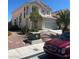 Charming two-story home featuring stucco exterior, well-maintained landscaping, and a two-car garage at 7228 Chic Ave, Las Vegas, NV 89129