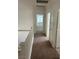 Upstairs hallway with carpet leading to the bedrooms and bathrooms at 7228 Chic Ave, Las Vegas, NV 89129