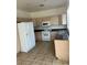 Functional kitchen with white appliances, tile floors, and ample cabinet space at 7228 Chic Ave, Las Vegas, NV 89129