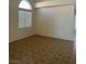 Bright living room features a window and a spacious layout with tile flooring at 7228 Chic Ave, Las Vegas, NV 89129