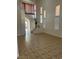 Bright living room features tile floors and a staircase with white railings at 7228 Chic Ave, Las Vegas, NV 89129