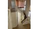 Elegant staircase with white railing and well-lit landing, leading to the upper floors of the home at 7228 Chic Ave, Las Vegas, NV 89129
