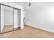 Bedroom features modern closet with mirrors, wood-look flooring, and ceiling fan at 831 Purple Sage Ter, Henderson, NV 89015