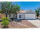 Charming home with desert landscaping, complemented by a beautiful tree and inviting entrance at 831 Purple Sage Ter, Henderson, NV 89015