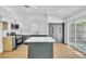 Modern kitchen features a central island, stainless appliances, and stylish cabinetry with outdoor access at 831 Purple Sage Ter, Henderson, NV 89015