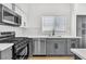 Well-equipped kitchen with stainless steel appliances, stylish cabinetry, and quartz countertops at 831 Purple Sage Ter, Henderson, NV 89015