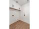 Well lit Laundry room features wood-look flooring and white cabinets at 831 Purple Sage Ter, Henderson, NV 89015
