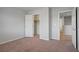 Carpeted bedroom with closet and hallway access at 9035 Drummer Bay Ave, Las Vegas, NV 89149