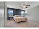 Spacious bedroom with a large bed, ceiling fan, and windows offering plenty of natural light at 9035 Drummer Bay Ave, Las Vegas, NV 89149