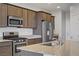 Well-equipped kitchen with stainless steel appliances, granite countertops, and sleek cabinetry at 9035 Drummer Bay Ave, Las Vegas, NV 89149