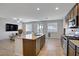 Beautiful kitchen with stainless steel appliances, an island with sink, and an adjacent living room at 9035 Drummer Bay Ave, Las Vegas, NV 89149